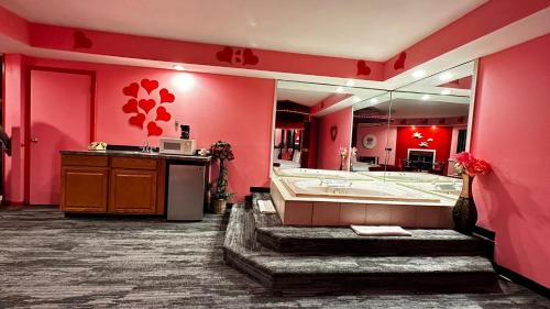 a pink bathroom with a tub and a large mirror at Inn of the Dove - Romantic Luxury Suites with Jacuzzi & Seasonal Fireplace at Harrisburg-Hershey-Philadelphia, PA in Harrisburg