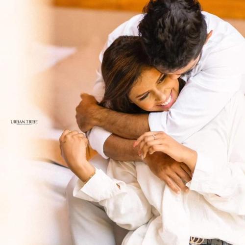 a man and woman hugging each other on a bed at Gabaa Resort & Spa - Habarana in Habarana