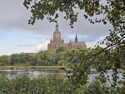 a large building with two towers on top of a lake at Suite - Mein Ankerplatz in Stralsund