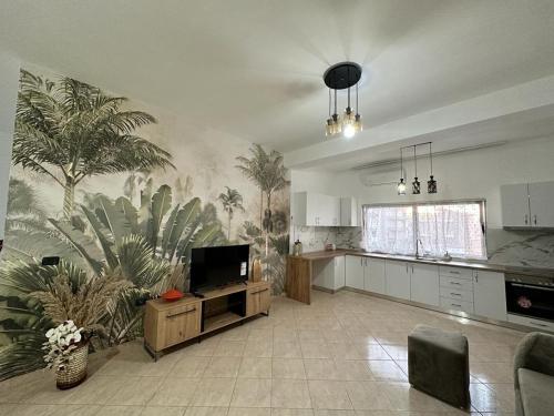 a large kitchen with a large palm mural on the wall at Victorias apartment Tirane in Tirana