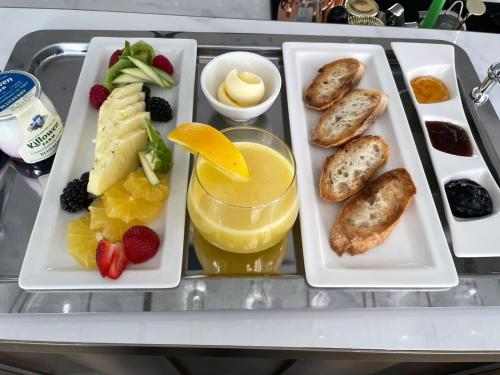 a tray with three trays of food on a table at Lusso Hometels J One Business Bay in Dubai