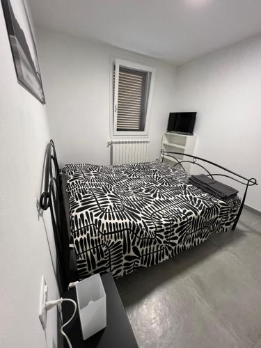 a black and white bed in a white room at San Rocco 30 - camera in campagna - Piombino in Piombino