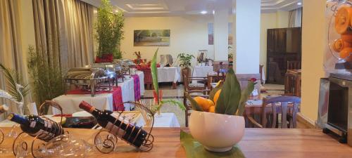 a dining room with a table with wine bottles on it at The Glacier Hotel Nanyuki in Nanyuki