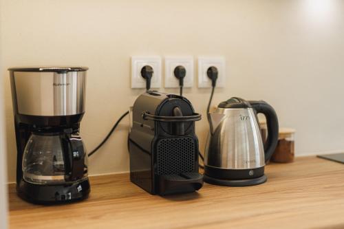 three appliances sitting on a wooden counter top at Lavish condo in Athens Riviera in Athens
