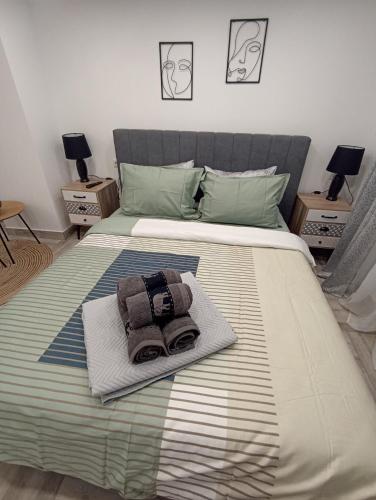 a bed with a towel and a bag on it at Колеви хаус in Gabrovo