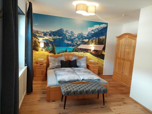 a bedroom with a mountain mural on the wall at Dolomitenhome Apartments in Patriasdorf