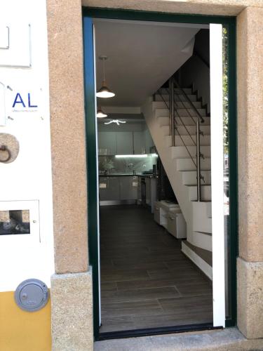 a glass door leading to a hallway with stairs at A Casinha Gomes in Nisa