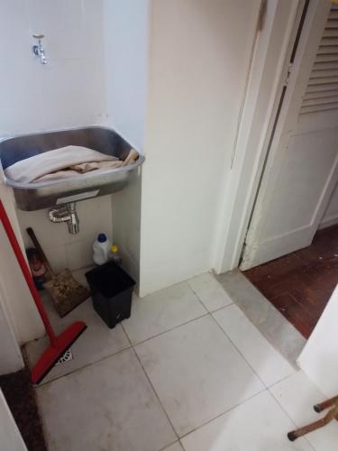 a bathroom with a sink next to a door at Suíte em catete in Rio de Janeiro