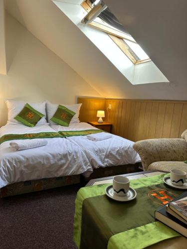 a bedroom with two beds and a skylight at Penzion u Fouska in Chodov