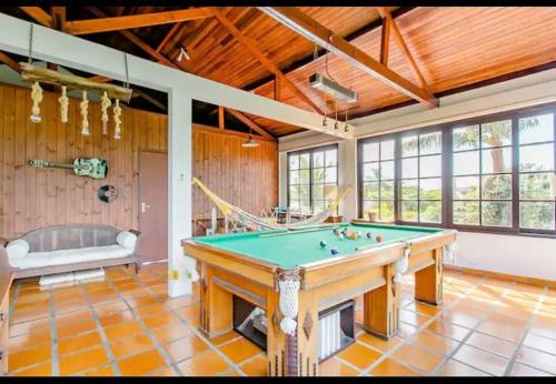 a large room with a pool table and a tub at The Cats' House in Florianópolis