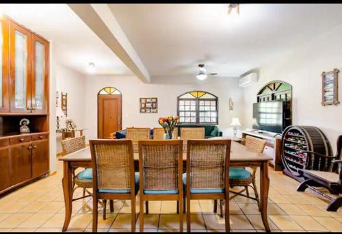a living room with a dining room table and chairs at The Cats' House in Florianópolis