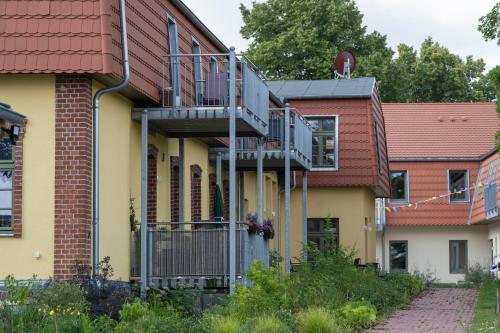 a house with a fire escape on the side of it at Ferienwohnungen - barrierefrei - im sanierten Gutshof in Lalendorf