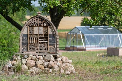 a bird house sitting in a pile of rocks at Ferienwohnungen - barrierefrei - im sanierten Gutshof in Lalendorf