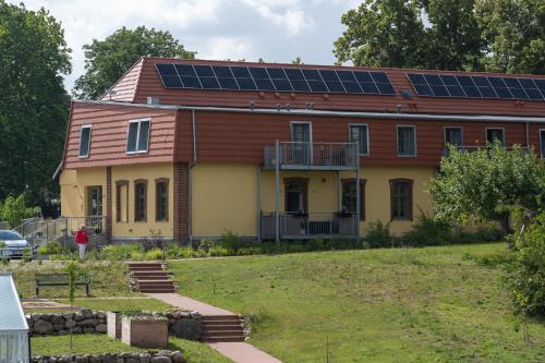 a house with solar panels on the roof at Ferienwohnungen - barrierefrei - im sanierten Gutshof in Lalendorf