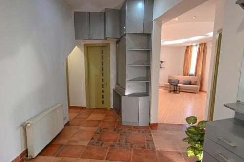 a room with a kitchen with a shelf and a hallway at Classic apt. on Liberty Square in Tbilisi City