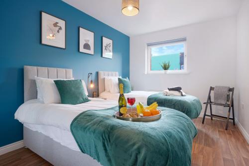 a hotel room with two beds with a tray of fruit at Stylish Apartment - Walking Distance to the City Centre - Free Parking, Fast Wi-Fi and SmartTV with Netflix by Yoko Property in Coventry