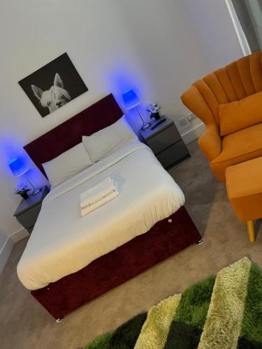 a bedroom with a large bed and a chair at Spacious 2 Bedroom Apartment in Woolwich Arsenal in Woolwich