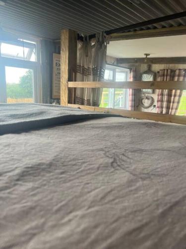 a room with a bed and a window at Bridie -rose with wood tub country retreat in Kington