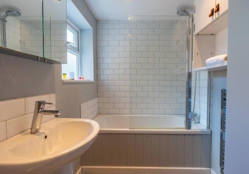 a bathroom with a tub and a sink and a shower at Gorgeous Garden Apartment *Cafes/Bars/Beach within minutes* in Kent