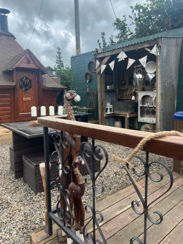 a wooden deck with a table and a house at Bridie -rose with wood tub country retreat in Kington