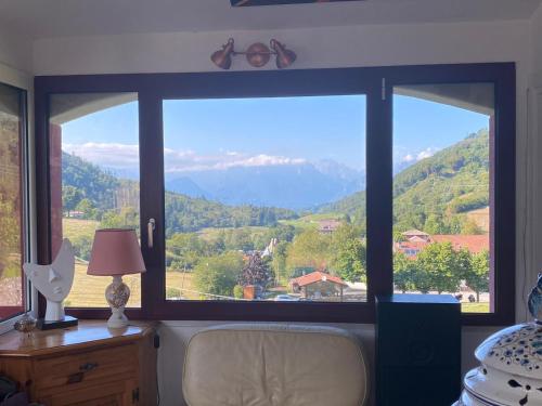 a bedroom window with a view of a mountain at B&B Al Casel in Tovena