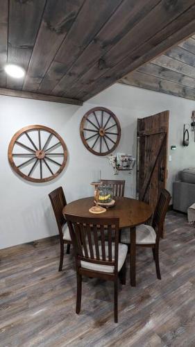 a dining room with a wooden table and chairs at Enjoy Ozark History in Style! in Hasty