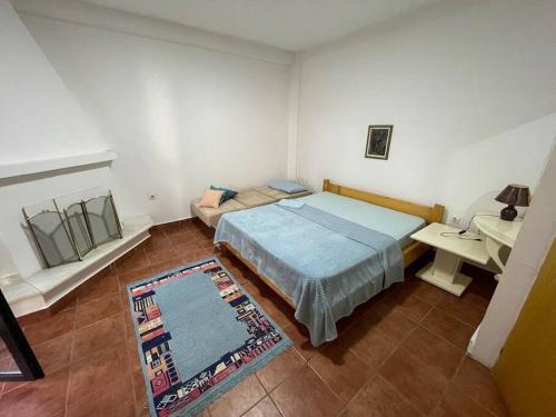 a bedroom with a bed and a desk and a table at Vila Zara in Gevgelija