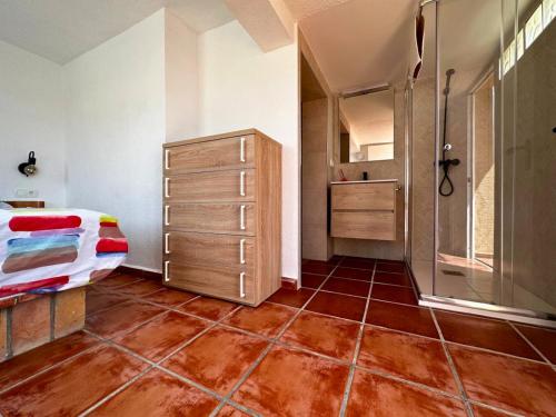 a bedroom with a bed and a dresser in it at Chalet en La Mata a 50 metros de la playa in Torrevieja