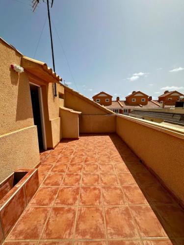 a balcony of a house with a tile floor at Chalet en La Mata a 50 metros de la playa in Torrevieja