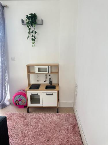 a small kitchen with a sink and a microwave at Water Front APT Walk to the Beach & City Centre in Swansea