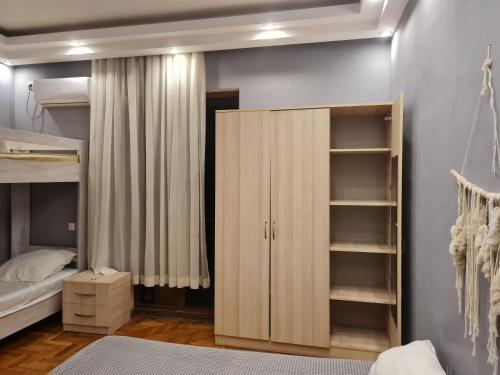 a bedroom with a bunk bed and a closet at Merabi Guest House in Makhinjauri