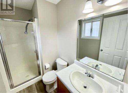 a bathroom with a sink and a shower and a toilet at Hinton Alberta Vacation Home in Hinton