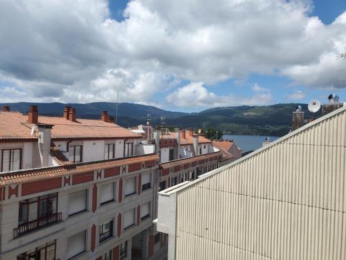 a view of a city with buildings and a body of water at ÁTICO EXCEPCIONAL TRANQUILO En LA PLAYA in Arcade