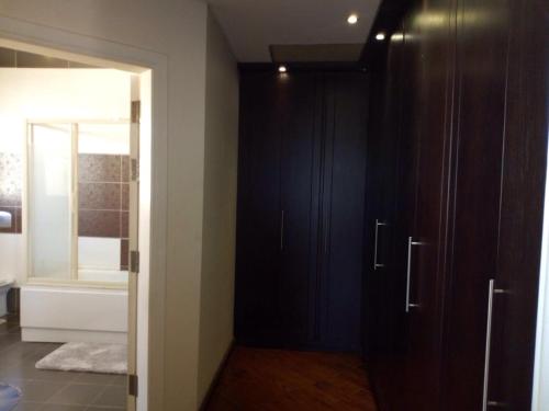 a bathroom with dark wood cabinets and a mirror at Heaven new Cairo Villa with Private pool and jacuzzi in Cairo