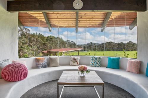 a living room with a couch and a table at Cozy Family Life Style Villa in Riverhead