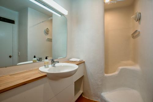 a bathroom with a sink and a mirror and a tub at Cozy Family Life Style Villa in Riverhead