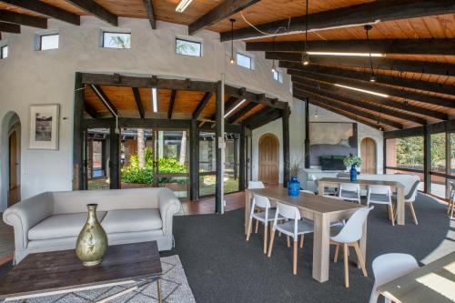 a living room with a couch and tables and chairs at Cozy Family Life Style Villa in Riverhead