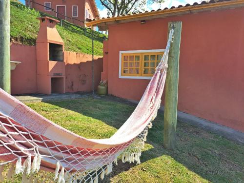 a hammock in front of a house at Pousada Vale das Araucárias in Santo Antônio do Pinhal