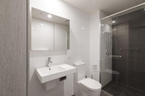 a bathroom with a sink and a toilet and a shower at The Calm in Newcastle