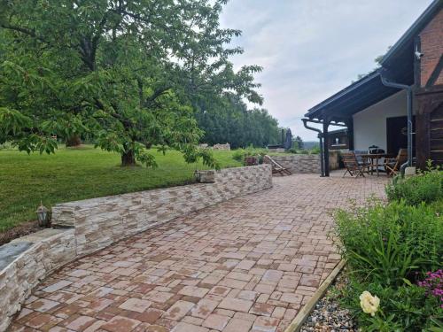 a brick walkway in front of a house at Luxusní apartmán s krbem - Kunratické Švýcarsko in Kunratice