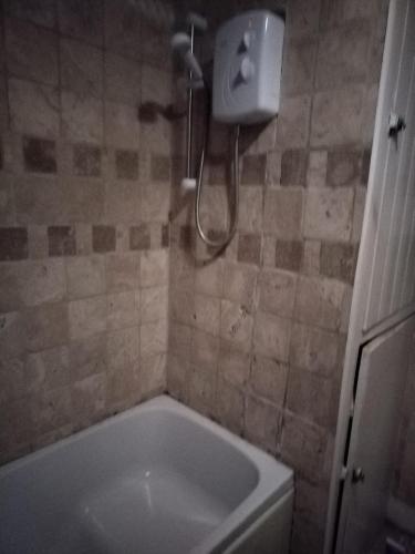 a bathroom with a tub and a shower at Room from home in Abbey Wood