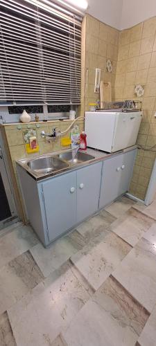 a kitchen with a sink and a counter at Sq Varnava apartment Athens in Athens