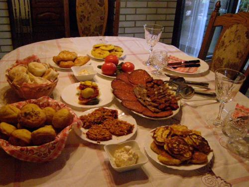 a table with many plates of food on it at Apartments Bakine Čarolije in Karanac