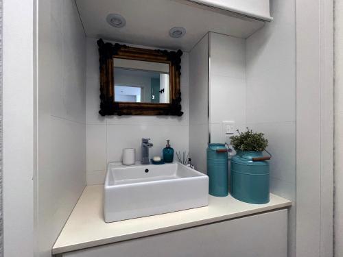 a bathroom with a white sink and a mirror at Primera linea de Playa de Martina in Almerimar