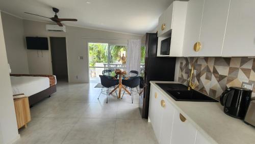 a kitchen and living room with a bed and a table at Studio Varia in Rarotonga