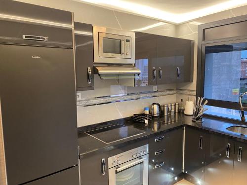 a kitchen with stainless steel appliances and a microwave at Casa Hamburg in Nador