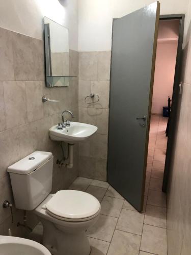 a bathroom with a toilet and a sink at Helenita in Villa Mercedes