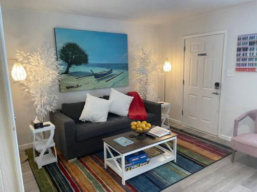 a living room with a couch and a table at Gulf Shores Getaway steps away from the pool! in Gulf Shores
