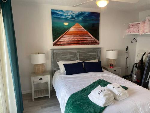 a bedroom with a bed with two towels on it at Gulf Shores Getaway steps away from the pool! in Gulf Shores