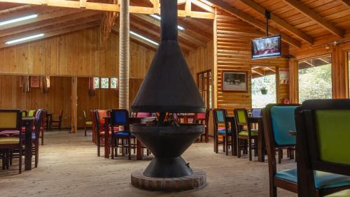 a dining room with a fire hydrant and tables and chairs at Hacienda La Lucha in Lucha